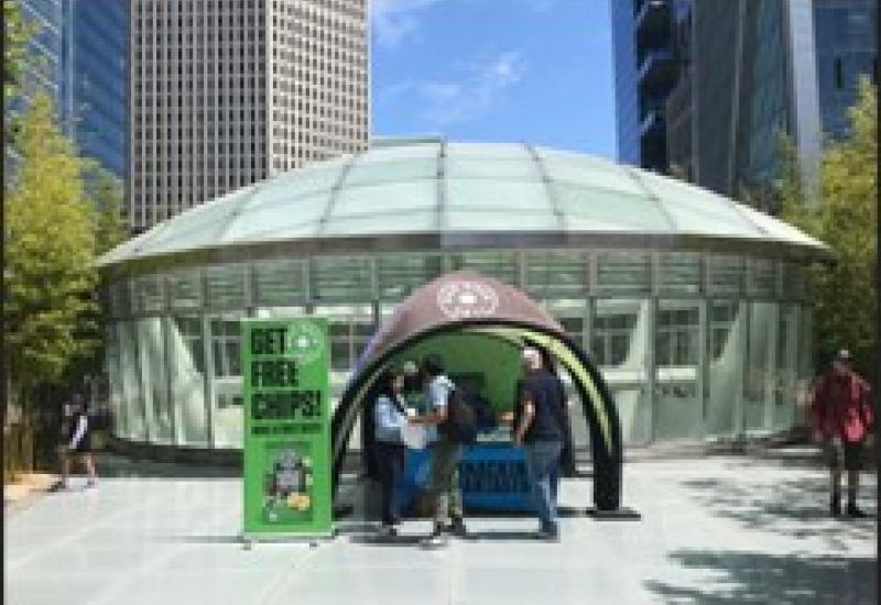 Information booth on the Main Plaza with people.