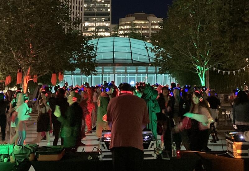 Photo of the Halloween Silent Disco at night in the Main Plaza.
